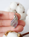 Raw amethyst necklace in hand for size reference, natural amethyst crystal, sterling silver artisan wire wrap