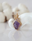 Detailed front view of raw amethyst pendant in 14k gold filled. Unique wire wrapped February birthstone jewelry by Designs by Nature Gems.