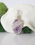 Back view of raw amethyst necklace pendant with handcrafted sterling silver wire work