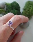 Raw amethyst ring for women in sterling silver claw setting, adjustable band on model hand