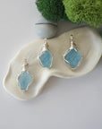 Three different raw aquamarine pendants displayed for variation reference