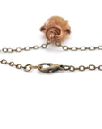 Close-up of a bronze chain with a clasp on a white background