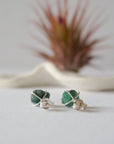 Back view of raw emerald stud earrings in sterling silver showing artisan setting and earring post detail