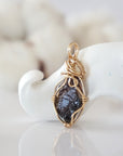 Back view of raw garnet pendant in 14k gold filled, highlighting stone and wire detail. One of a kind January birthstone jewelry by Designs by Nature Gems.