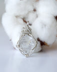 Back view of raw Herkimer diamond pendant for women with handcrafted 925 sterling silver wire wrapping.