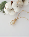 Raw opal necklace in 14k gold filled laying flat. Handcrafted October birthstone jewelry for women by Designs by Nature Gems.