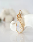 Side view of raw opal pendant in 14k gold filled, showing artisan wire wrapping. Handcrafted October birthstone necklace by Designs by Nature Gems.