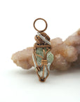 Right side detail of handmade raw peridot pendant for men — antique bronze and dark silver wire wrapping technique, artisan crystal necklace by Designs by Nature Gems