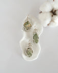 Three raw peridot pendants showing natural variation in stone size, shape, and green colour — each one of a kind, August birthstone, silver wire wrapped, Designs by Nature Gems
