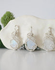 Three raw rainbow moonstone necklaces showing natural crystal variations and blue flash in handmade wire wrapped pendants