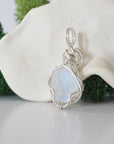 Back view of raw rainbow moonstone necklace pendant with handcrafted sterling silver wire work