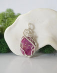 Front view of raw pink ruby pendant — natural unpolished ruby stone hand-wrapped in detailed 925 sterling silver wire, handcrafted artisan jewelry