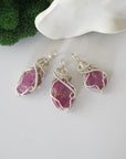 Three raw ruby pendants showing natural variation in stone size, shape, and pink colour — each one of a kind, July birthstone, 925 sterling silver wire wrapped, Designs by Nature Gems