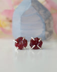 Front view of raw ruby prong stud earrings showing open claw 925 sterling silver setting — minimalist natural crystal earrings for women