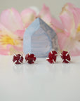 Two pairs of raw ruby prong stud earrings showing natural variation in stone shape, size, and colour — select your own pair, one of a kind by nature