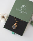 Raw sapphire necklace in 14k gold filled displayed in branded Designs by Nature Gems jewelry box. Artisan September birthstone gift for women.