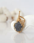 Detailed front view of raw sapphire pendant in 14k gold filled. Unique wire wrapped September birthstone jewelry by Designs by Nature Gems.