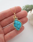 Raw turquoise necklace in 14k gold filled shown in hand for size reference. Artisan December birthstone pendant by Designs by Nature Gems.