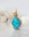 Detailed front view of raw turquoise pendant in 14k gold filled. Unique wire wrapped December birthstone jewelry by Designs by Nature Gems.