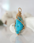Side view of raw turquoise pendant in 14k gold filled, showing artisan wire wrapping. Handcrafted December birthstone necklace by Designs by Nature Gems.