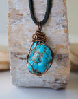 Raw turquoise pendant men copper wire wrapped back side showing secure wrap