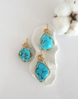 Three raw turquoise pendants in 14k gold filled, showing natural variation in size, shape, and color. Handcrafted December birthstone jewelry by Designs by Nature Gems.