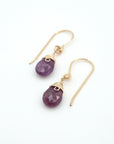 Angled look at ruby drop earrings, artisan wire wrapping in 14k gold filled, July birthstone