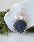 Detailed front view of silver wire wrapped sapphire and freshwater pearl pendant, unique artisan necklace
