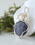 Side angle of handmade sapphire and freshwater pearl pendant necklace, silver wire wrapped jewelry