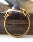 Detail of approximately 4mm sapphire ring band with antique bronze and dark silver wire-wrapped artisan finish