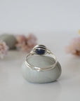 Back-angle view of silver sapphire ring revealing the handcrafted minimalist wire-wrapped band and artisan finish