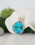 Back view of simple wire wrapped raw turquoise pendant showing clean silver plated copper craftsmanship
