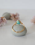Back view of simple turquoise ring in gold plated copper showing handmade wire wrapping detail and craftsmanship quality