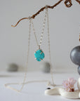 Sterling silver turquoise necklace close up showing claw setting and raw stone detail