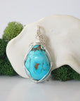 Back view of 925 silver wire wrapped raw turquoise pendant showing detailed craftsmanship and artisan technique