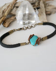 Right side view of natural turquoise stone with detailed antique bronze wire wrapping on leather bracelet, handmade artisan detail