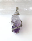 Back side angle of women’s raw amethyst pendant necklace wire wrapped in white gold plated copper