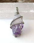 Detailed front view of women’s raw amethyst pendant wire wrapped in white gold plated copper