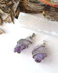 Two women’s raw amethyst pendant necklaces showing natural variation in amethyst color, shape, and size