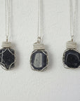 Three sapphire necklaces for men – showing natural variation in size, shape, and shade of blue, 925 sterling silver wire wrapping.