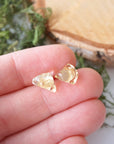 Natural citrine stud earrings held in hand showing size comparison - unisex raw crystal sterling silver studs