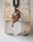Handcrafted clear quartz point necklace for men, front view – artisan antique bronze copper wire wrapping, April birthstone, black leather cord.