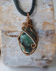 Back view of handcrafted men's emerald necklace – natural stone and wire wrapping, May birthstone, black leather cord.
