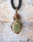 Back view of handcrafted men's peridot necklace – natural stone and wire wrapping, August birthstone, black leather cord.