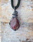 Back view of handcrafted men's ruby necklace – natural stone and wire wrapping, July birthstone, black leather cord.