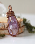 Right side angle of women’s amethyst necklace, lighter violet amethyst, antique bronze copper wire wrap
