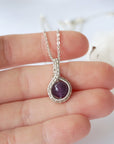 Women’s silver amethyst necklace in hand for size reference, 8mm amethyst bead, artisan silver plated copper wire wrap