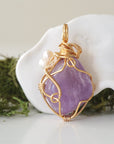 Back angle detail of amethyst and freshwater pearl pendant, showing wire wrapping and natural stone