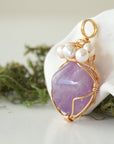 Side angle detail of amethyst and freshwater pearl pendant, gold wire wrapped, ethical artisan necklace