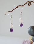 Side view of silver plated copper wire wrapped drop earrings featuring 6mm amethyst bead and 6mm rose quartz bead